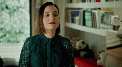 Woman In Green Lace Dress And Red Lipstick Standing In Room GIF