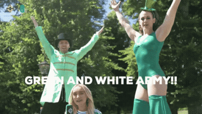Woman In Green Leotard Next To Man In Jacket And Top Hat GIF
