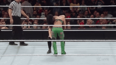 Woman In Green Pants Kneeling In Wrestling Ring With Referee GIF