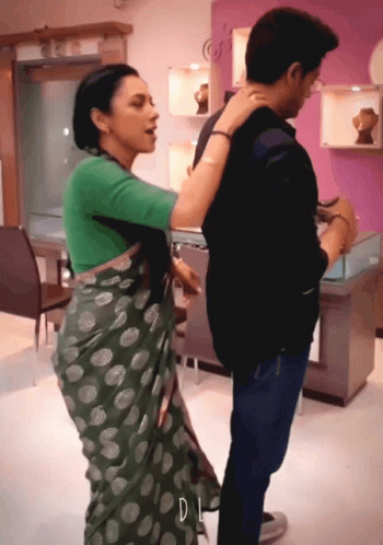 Woman In Green Polka Dot Saree Next To Man GIF