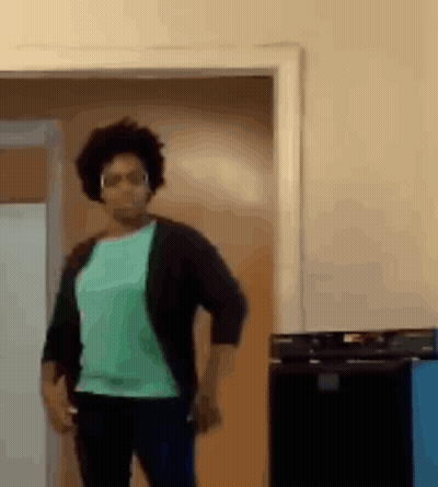 Woman In Green Shirt And Black Cardigan Dancing GIF