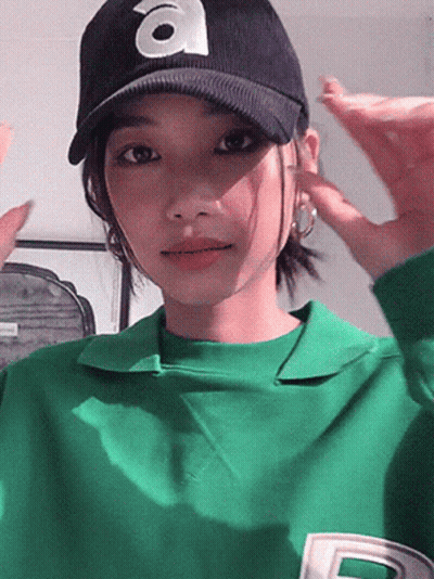 Woman In Green Shirt And Hat With Letter A GIF