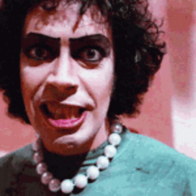Woman In Green Shirt And Pearl Necklace GIF