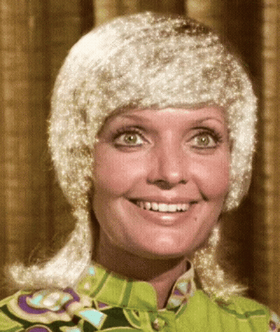 Woman In Green Shirt And White Wig Smiles GIF