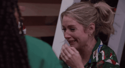 Woman In Green Shirt Crying Man Holding Hand GIF
