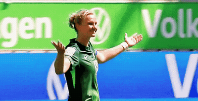 Woman In Green Shirt In Front Of VW Sign GIF