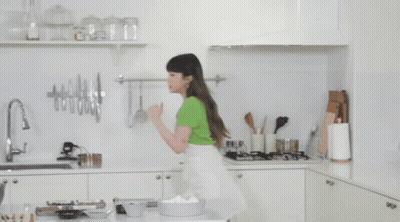 Woman In Green Shirt In Kitchen GIF