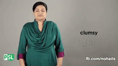Woman In Green Shirt Making Clumsy Sign GIF