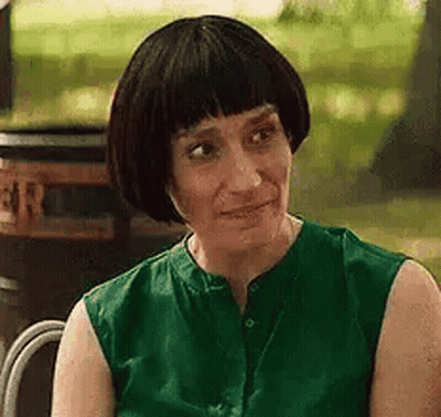 Woman In Green Shirt Sitting In Chair GIF