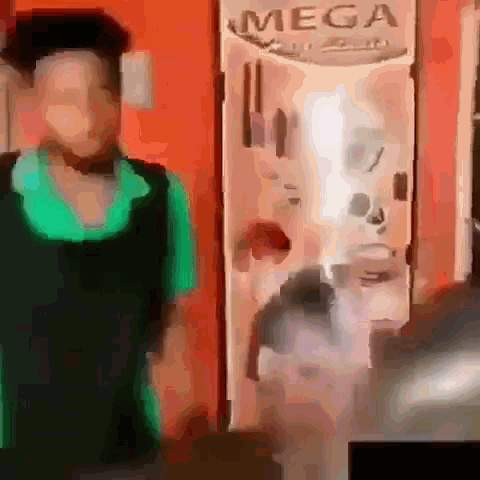 Woman In Green Shirt Standing In Front Of Mega Sign GIF