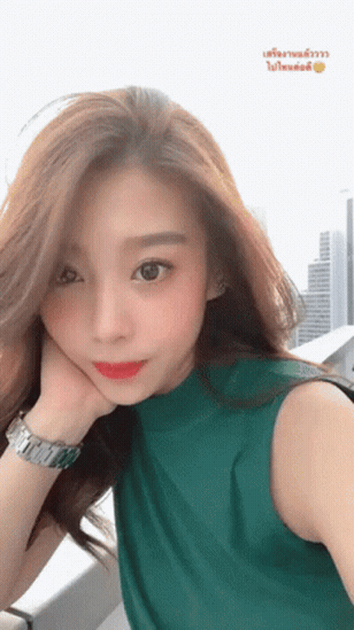 Woman In Green Shirt Taking Selfie GIF