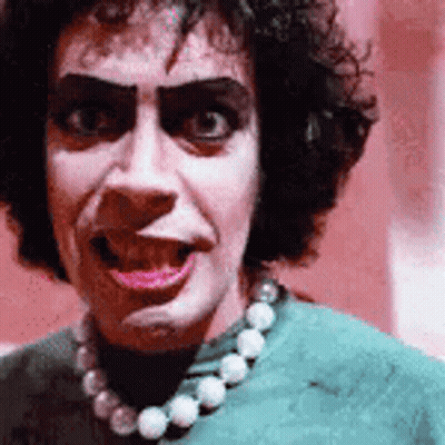 Woman In Green Shirt With Pearl Necklace GIF