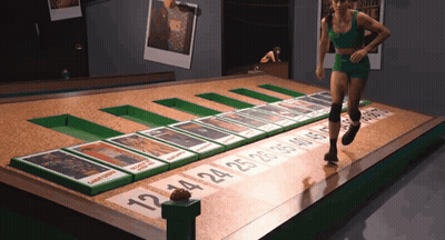 Woman In Green Shorts Running Across Cards 12 14 25 GIF