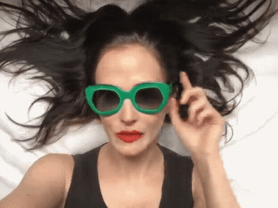 Woman In Green Sunglasses And Red Lips Lying GIF
