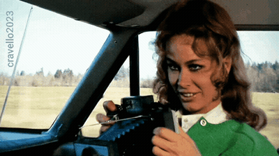 Woman In Green Sweater Holding Steering Wheel Cravello 2023 GIF