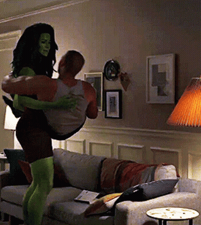 Woman In Green Tights Carrying Man GIF