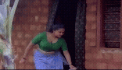 Woman In Green Top And Blue Skirt GIF