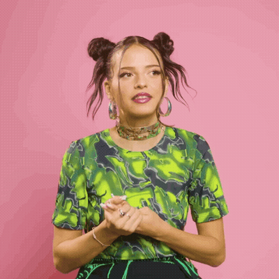 Woman In Green Top And Earrings Making Gesture GIF