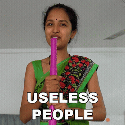 Woman In Green Top Holding Pink Stick Saying Useless People GIF