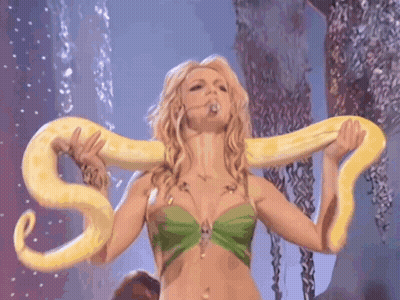 Woman in Green Top Holding Yellow Snake Around Neck