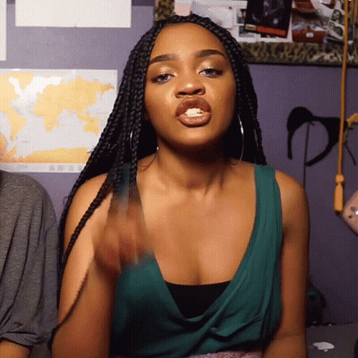 Woman In Green Top Making Rude Gesture GIF