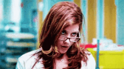 Woman In Green Top With Gold Necklace Arms Crossed GIF
