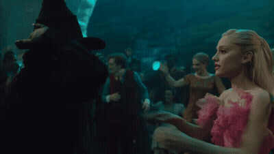 Woman In Green Witch Costume Hugging Another Woman GIF