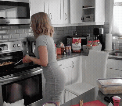 Woman In Grey Dress Cooking GIF