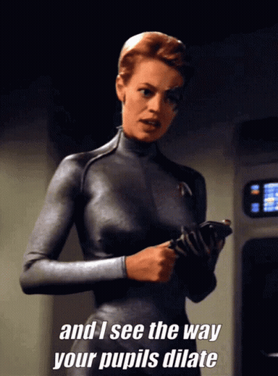 Woman In Grey Suit Saying Pupil Dilation GIF