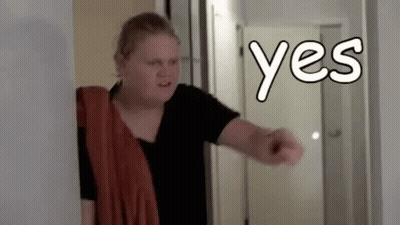 Woman In Hallway With Towel Pointing Yes GIF