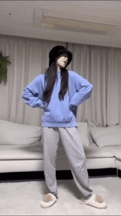 Woman In Hat And Blue Hoodie Dancing In Living Room GIF