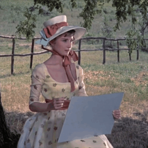 Woman In Hat And Dress Holding Paper GIF