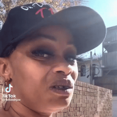 Woman In Hat And Earrings Making Funny Face GIF