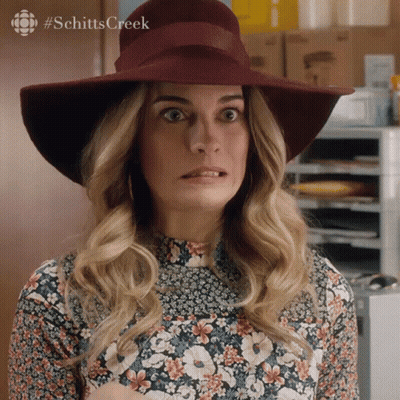 Woman In Hat And Floral Shirt Making Funny Face GIF