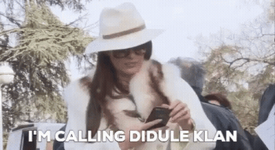 Woman In Hat And Fur Coat Calling Didule Klan GIF