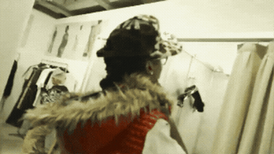 Woman In Hat And Fur Vest In Dressing Room GIF