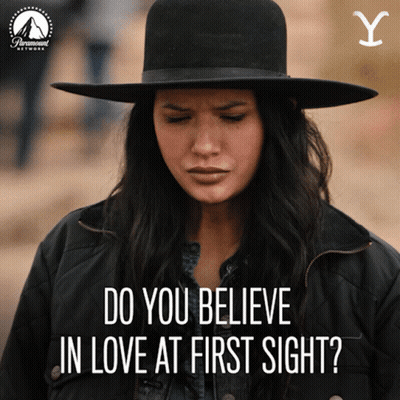 Woman In Hat And Jacket Saying Do You Believe In Love At First Sight GIF