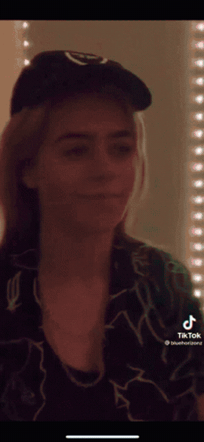 Woman In Hat And Necklace Before Blue Light GIF