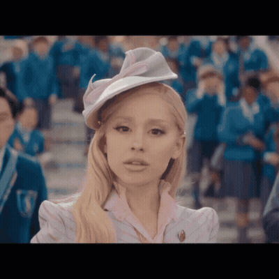 Woman In Hat And Pink Shirt Before Crowd GIF