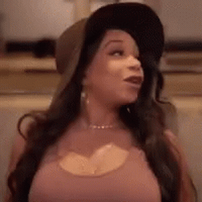 Woman In Hat And Pink Shirt Standing In Room GIF