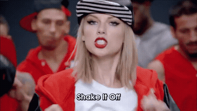 Woman In Hat And Red Jacket Says Shake It Off GIF