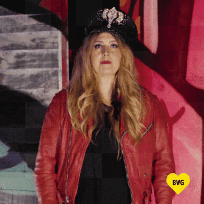 Woman In Hat And Red Jacket With Yellow Heart Saying BG GIF