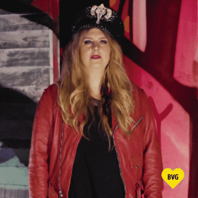 Woman In Hat And Red Jacket With Yellow Heart Saying BG GIF