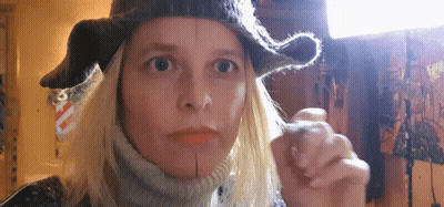 Woman In Hat And Scarf Looking At Camera GIF