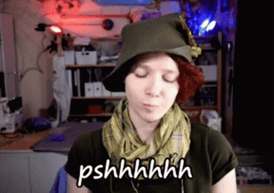 Woman In Hat And Scarf Says Pshhhhhh GIF