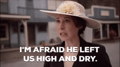 Woman In Hat And Suit Says I'm Afraid He Left Us High And Dry GIF