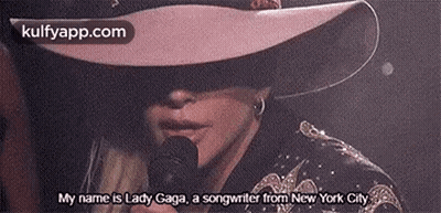 Woman In Hat And Sunglasses Holding Microphone GIF