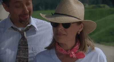 Woman In Hat And Sunglasses Next To Man GIF