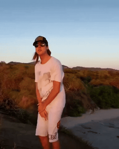Woman In Hat And Sunglasses On Dirt Road GIF
