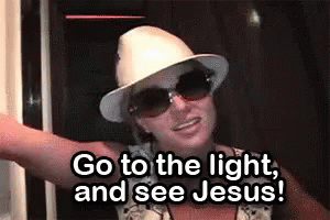 Woman In Hat And Sunglasses Saying Go To The Light GIF